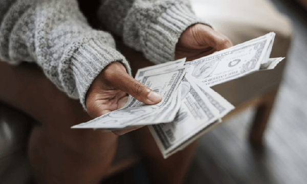 image of person holding money