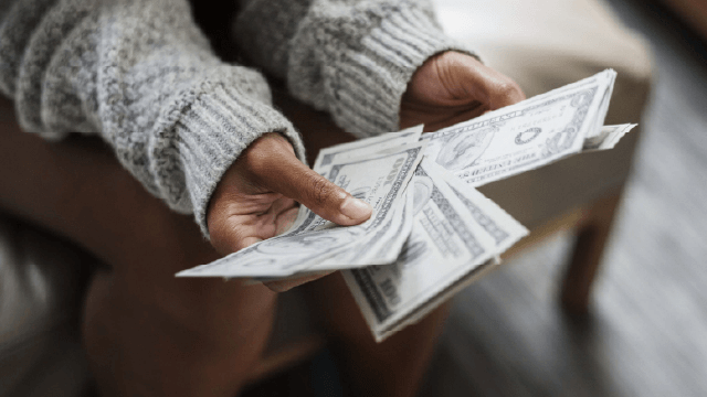image of person holding money