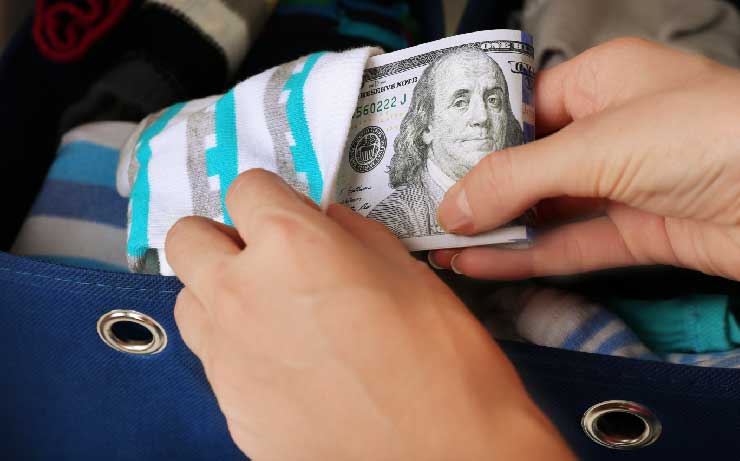 Person hiding money in a sock basket