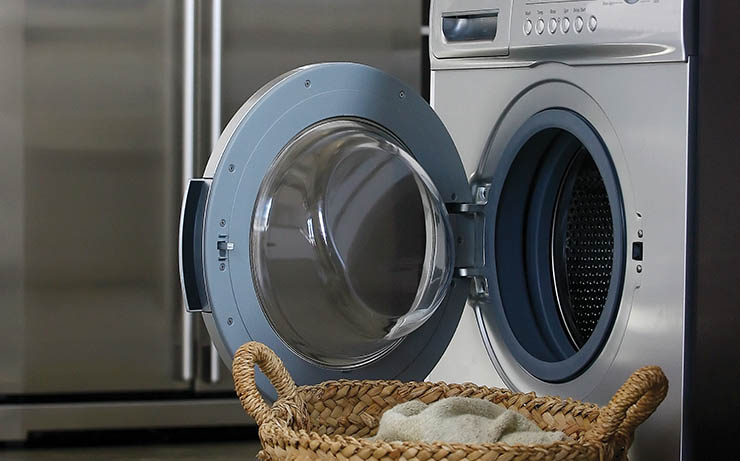 Laundry Machine in Kitchen With Laundry Basket