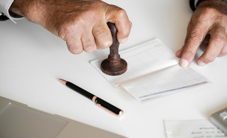 Man stamping a check with a notary stamp