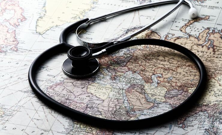 Black stethoscope laying on a on a map