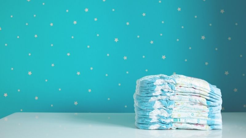 a stack of diapers on a table with a blue background with white stars