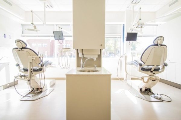Clean and white dental office with two seats for patients