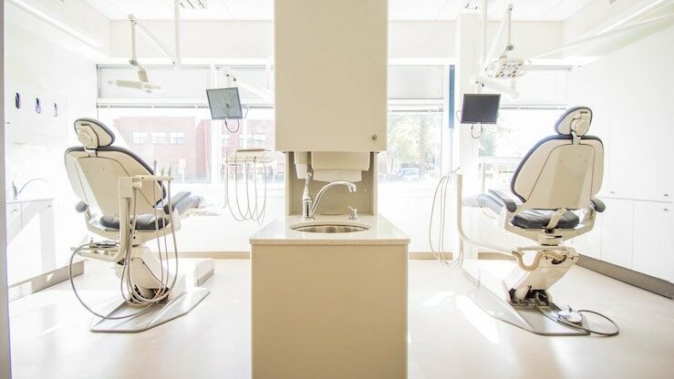 Clean and white dental office with two seats for patients