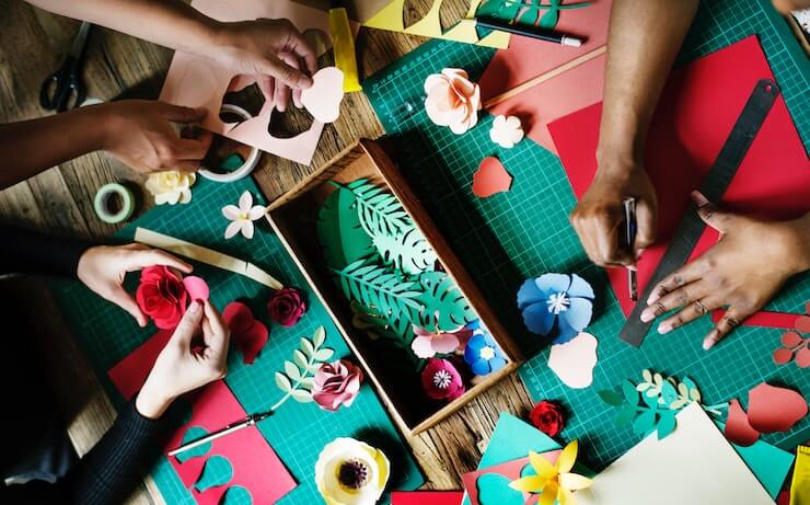 Friends crafting flowers to sell online