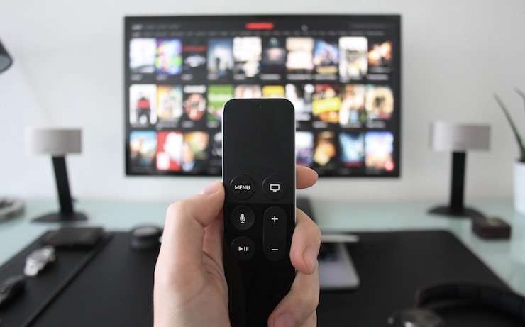 Person holding a TV streaming remote while picking out a show to watch