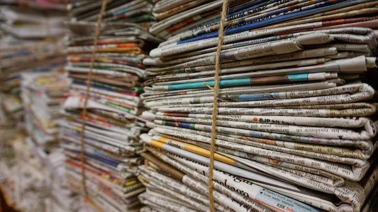 Stacks of news papers to be recycled bound with twine