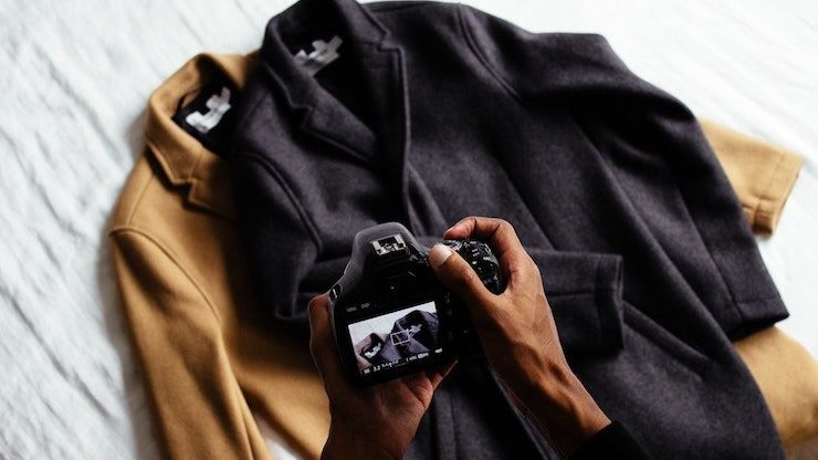 Person taking photo of two jackets that are for sale