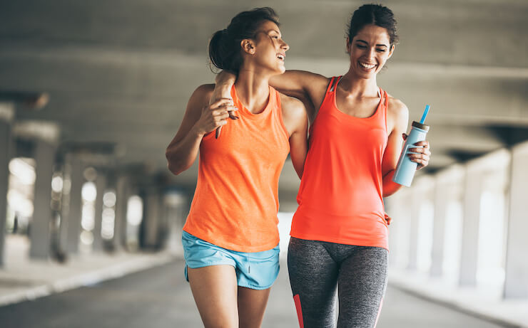 Two friends recovering after a workout