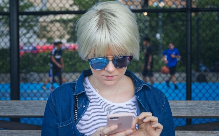 Woman looking at phone at a park