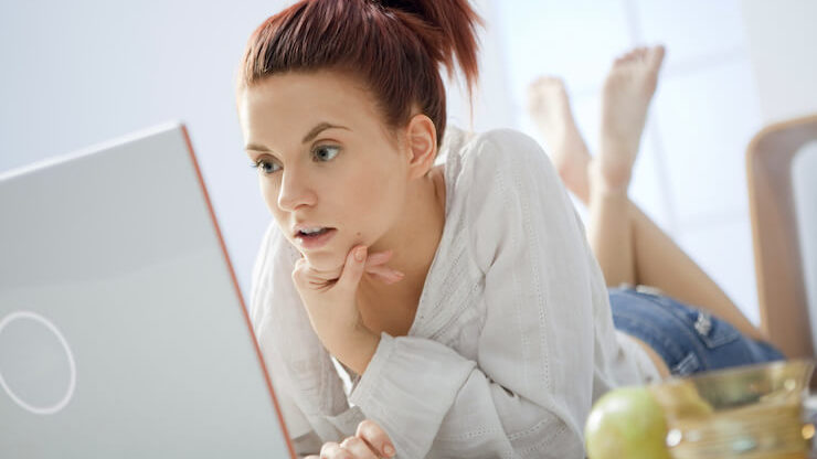 Woman surprised while looking into boglehead online