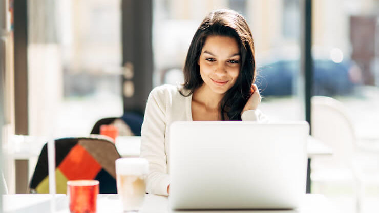 Woman looking into website hosting on her laptop