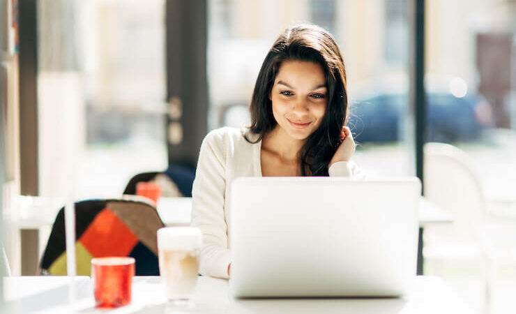 Woman looking into website hosting on her laptop