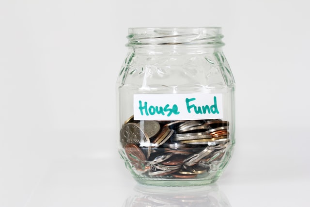 change in jar that says House Fund