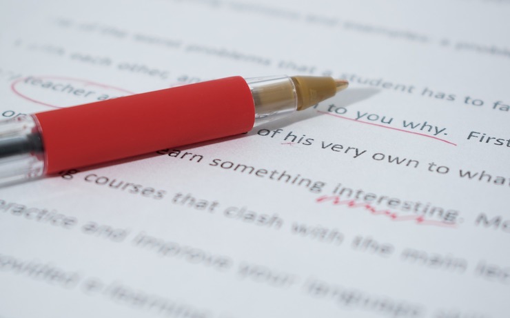 Close up photo of proofreading on paper with a red pen