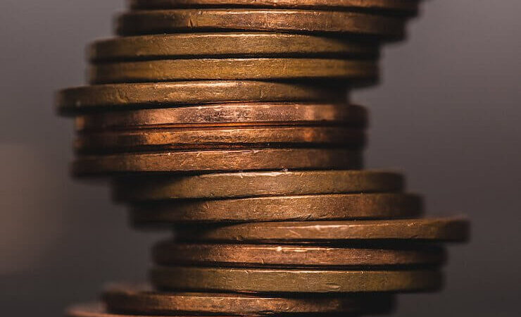 Close up photo of pennies stacked up with blurry background