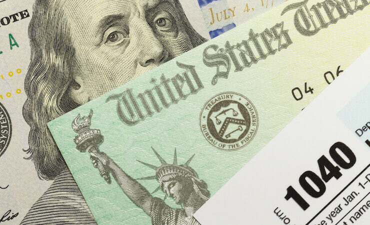 Close up photo of tax form, tax return and hundred dollar bill