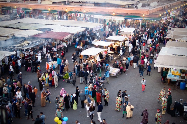 booths at a flea market with people shopping