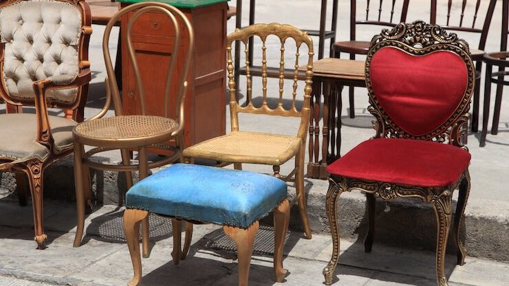 Old different pieces of furniture and chairs sitting on sidewalk