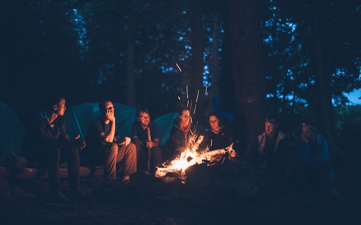 group of friends around a fire night fun