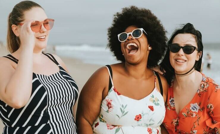 3 happy girls laughing while at the beach talking about future retirement