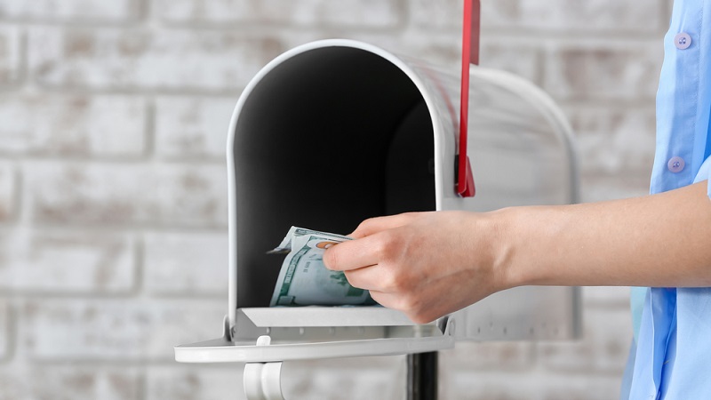 Woman getting money from mailbox 