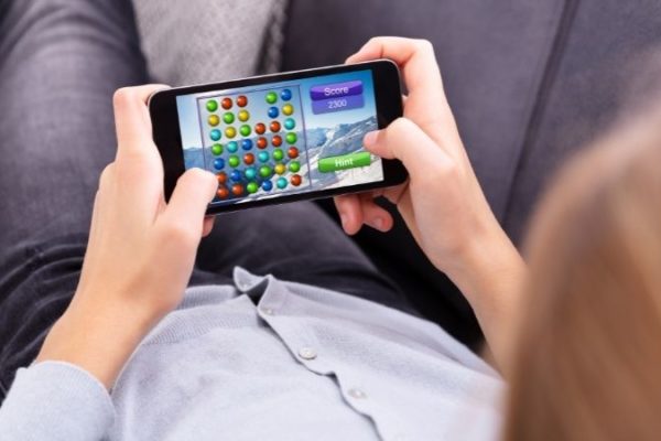 man playing game on cell phone