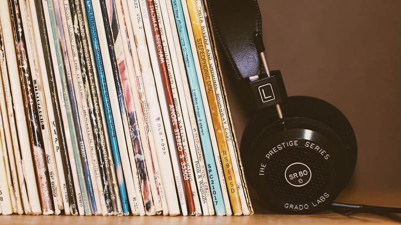 vinyl records on a shelf with headphones