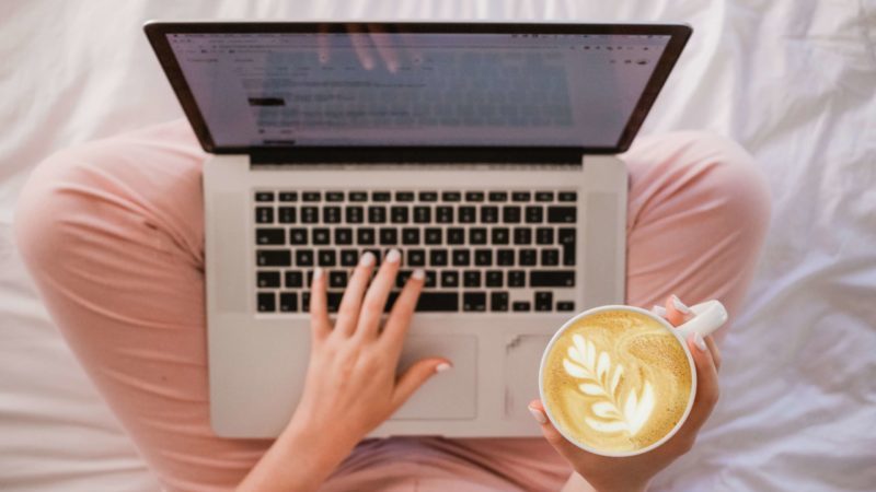 woman on laptop with cup of coffee