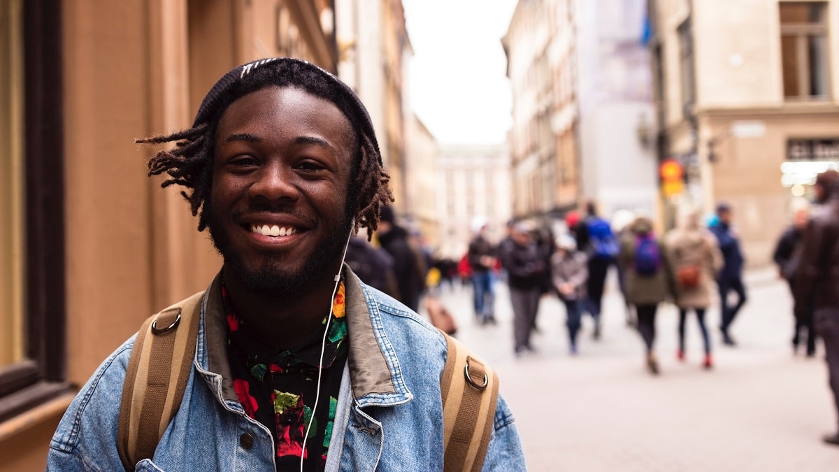 teen walking while smiling