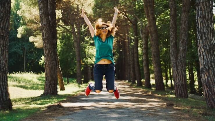 woman happy she got hired jumping for joy