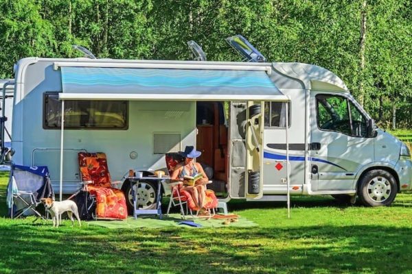 Woman reading a book outside while RV camping