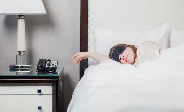 Woman Sleeping on Hotel Bed