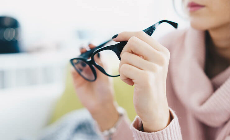 Woman looking at glasses at discount store