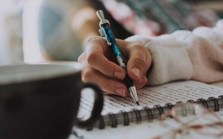 Woman writing poetry in her journal